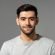 close-up-portrait-of-smiling-handsome-young-caucasian-man-face-looking-at-camera-on-isolated-light-gray-studio-background-photo